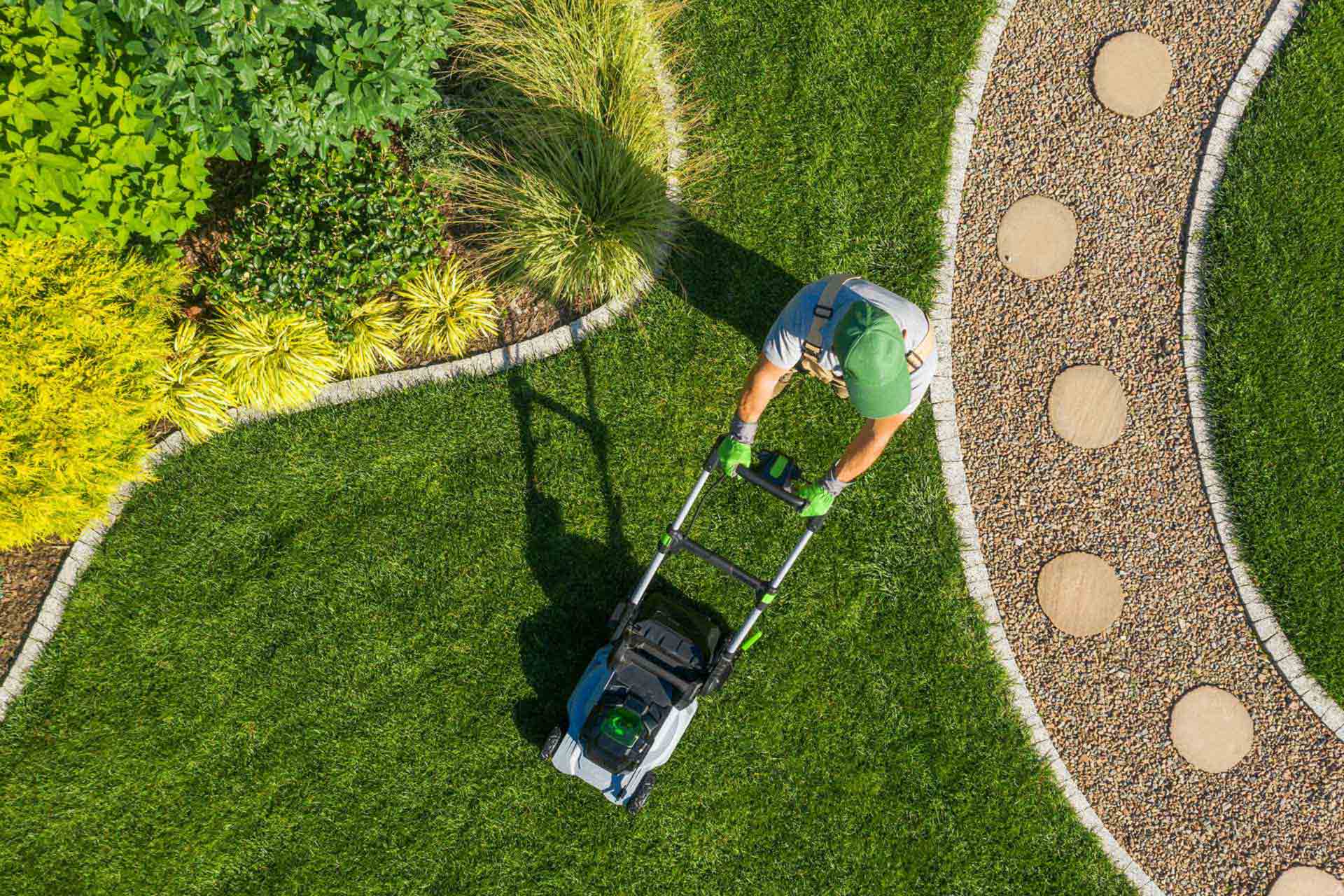 gardener-mowing-backyard-garden-grass-aerial-view-46ksduz